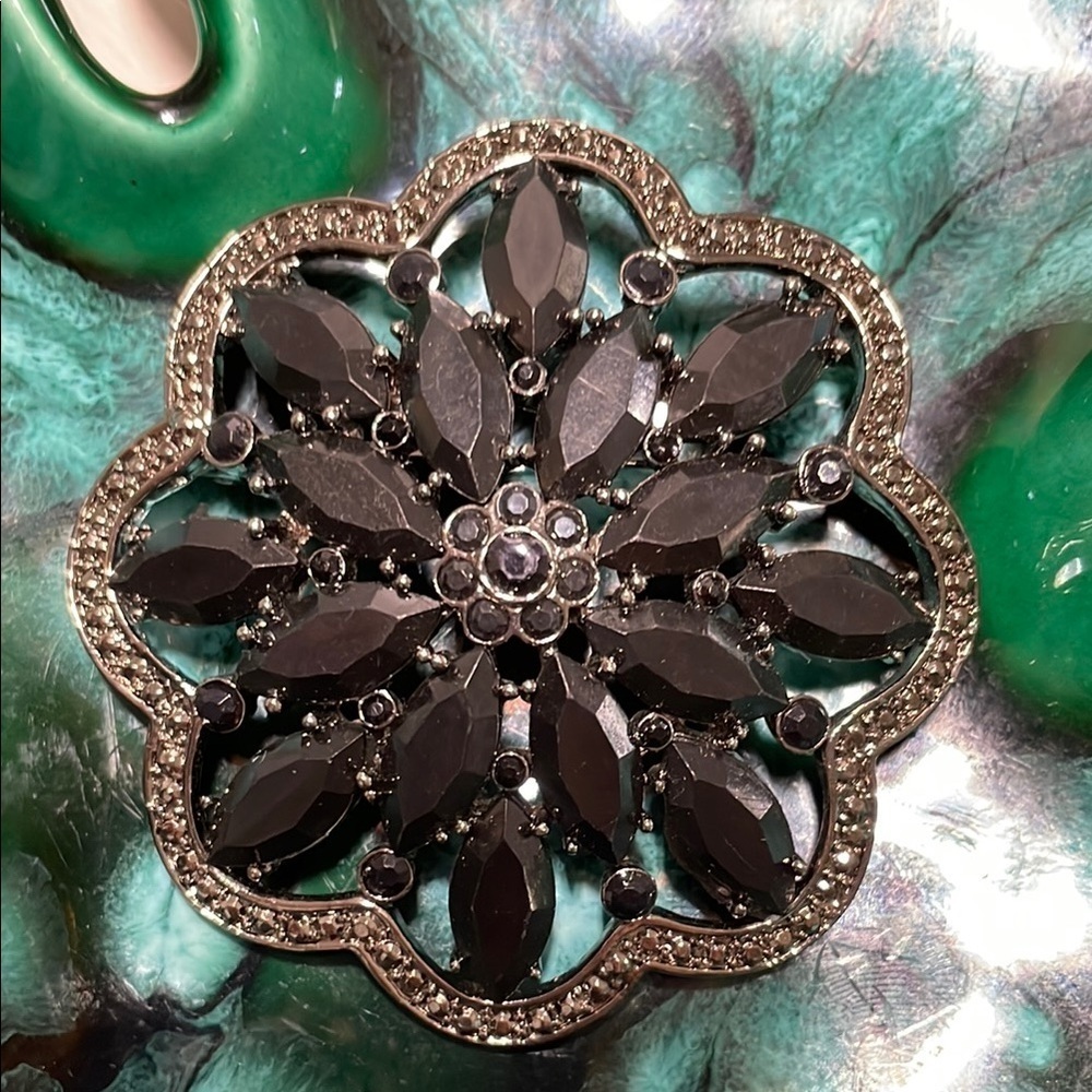 Intricate Black and Silver Floral Brooch with Textured Design